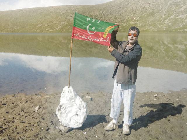 PTI activist hoists party flag at high-altitude Rush Lake