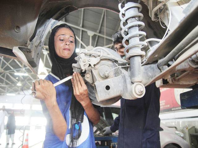 Female car mechanic driving change