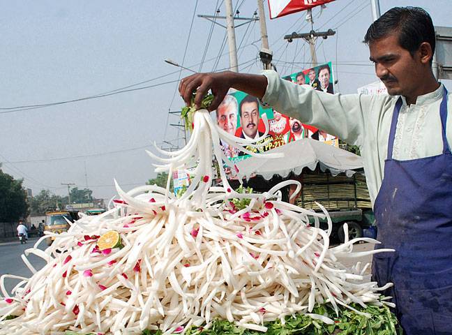Vendors arranging cages, flowers, radish and milk pots