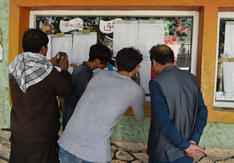 Afghan election observers check the voting results