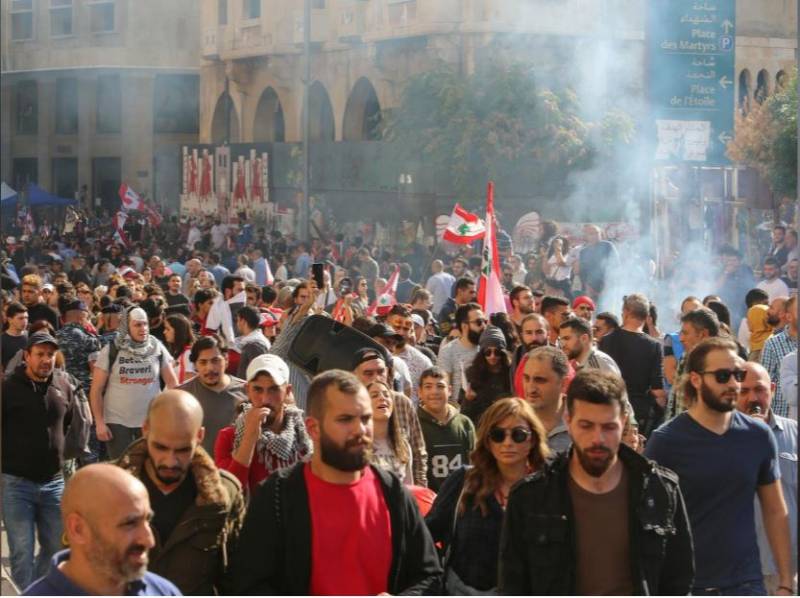 Protests force Lebanese parliament to postpone session, banks reopen
