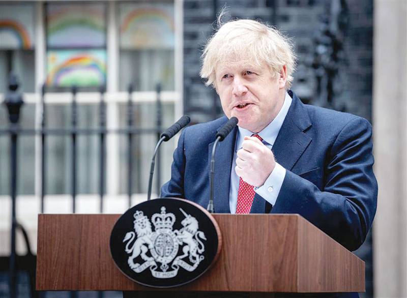 Back at work, British PM warns against easing virus lockdown
