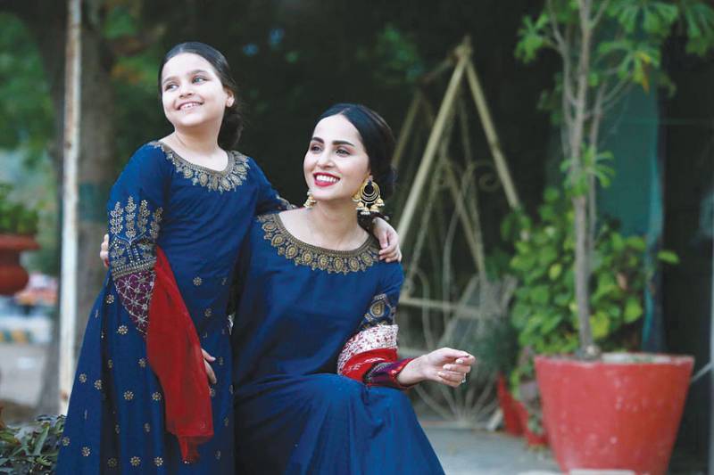 Nimra Khan smiles while posing with her little sister