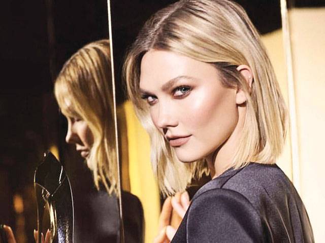 Karlie Kloss shows off her supermodel pins in a perfume ad