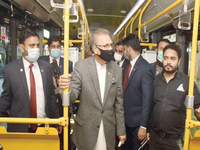 President Alvi rides on Green Line bus, expresses satisfaction over service