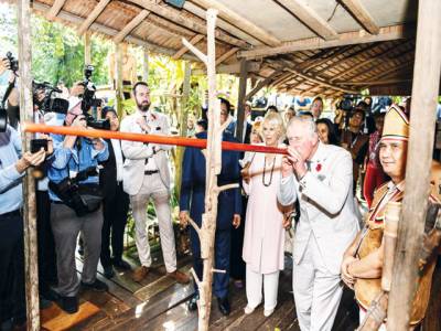 Prince Charles shoots blowpipe in Borneo