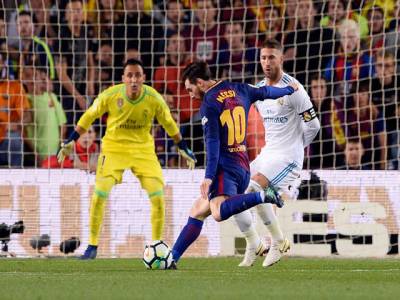 Messi helps 10-man Barca earn Real draw